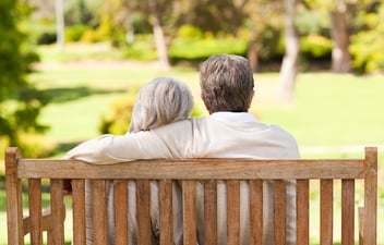 Older couple, sitting on a bench, talking about the new Medicare GUIDE Model.
